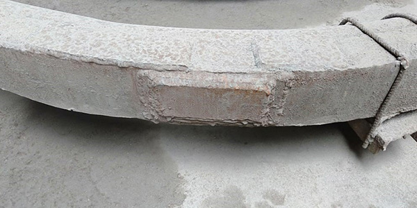 Old cement-patched elbow pipe