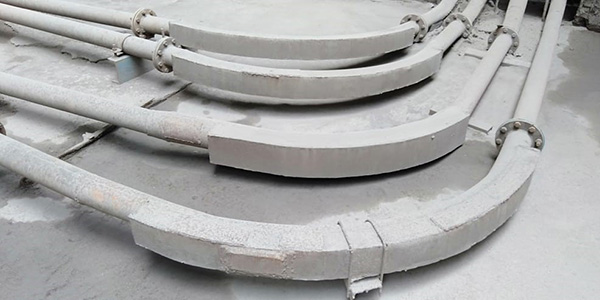 Old cement-patched elbow pipe